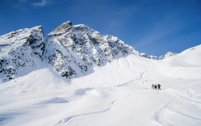 Skitouring with amazing view of famous mountains in beautiful winter powder snow of Alps